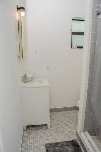 a white bathroom with a sink and a tub at Central location in Cutler Bay