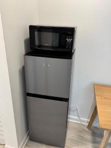 a microwave sitting on top of a refrigerator at Central location in Cutler Bay
