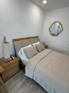 a bedroom with a bed and a mirror on the wall at Central location in Cutler Bay