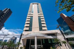 a tall building with a blue sky in the background at Studio w/ pool & barbecue in the building RAQ1609 in Salvador