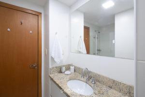 a bathroom with a sink and a mirror at Studio w/ pool & barbecue in the building RAQ1609 in Salvador +14 photos