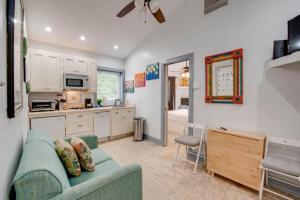 a living room with a couch and a kitchen at Yellowfin Ledge in Key West