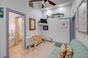 a living room with a blue couch and a chair at Yellowfin Ledge in Key West