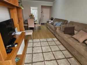 a living room with a couch and a table at Apartamento Beira-mar praia centro itapema in Itapema