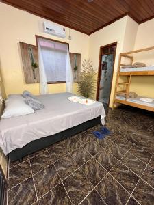 a bedroom with a bed and a bunk bed at Hostel Povos da Floresta in Rio Branco
