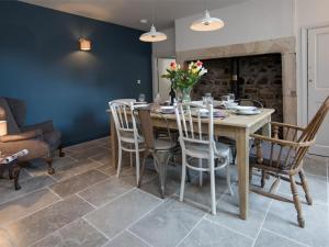 a dining room with a wooden table and chairs at 4 Bed in Bamburgh oc-cn089 in Bamburgh