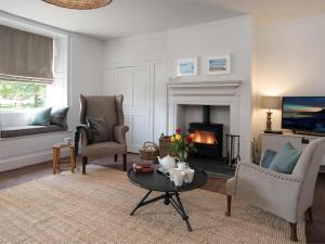 a living room with a table and a fireplace at 4 Bed in Bamburgh oc-cn089 in Bamburgh