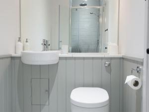 a white bathroom with a toilet and a sink at 4 Bed in Bamburgh oc-cn089 in Bamburgh +18 photos