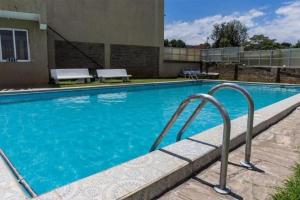 a large swimming pool with blue water at Perfect Palm Condos-P2 in Nakuru