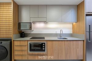 a kitchen with a sink and a microwave at Modern studio in Downtown Floripa CMA0101 in Florianópolis