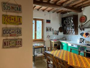 a kitchen with a table and a dining room at La Casa Di Cosimo Guest House in San Piero a Sieve