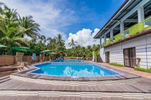 a swimming pool in front of a building at Mamburise Resort in Batan +13 photos