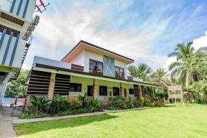 a house with a lawn in front of it at Mamburise Resort in Batan