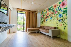 a living room with a couch and a painting on the wall at Mamburise Resort in Batan