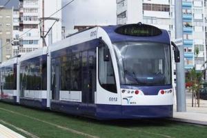 a blue and white tram on a city street at Blue House - double bed in Almada