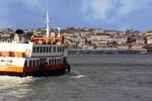 a ferry boat in the water with a city in the background at Blue House - double bed in Almada +3 photos