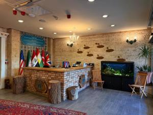 a lobby with a bar with a fish tank at Khan Saray in As Sulaymānīyah