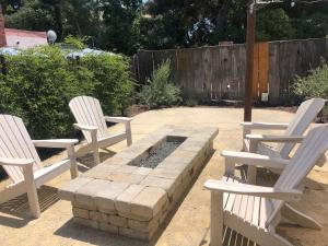 three white chairs and a fire pit in a yard at Home Squared-Downtown with Fire Pit in Paso Robles