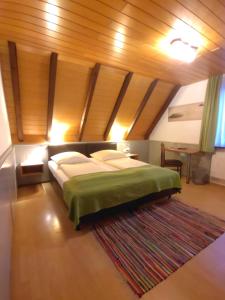 a bedroom with a bed in a room with a wooden ceiling at Hotel Smart-Inn in Erlangen