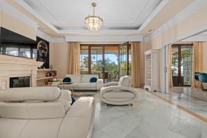 a living room with white furniture and a fireplace at Villa Picasso Marbella in Marbella