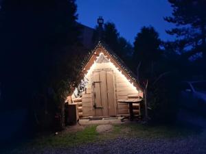 a small house with a door in the dark at U Sarapatki-Noclegi z wyżywieniem in Jurgów