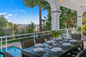 a dining table on the balcony of a villa at Villa Picasso Marbella in Marbella