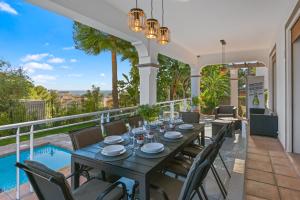 a dining table and chairs on the balcony of a house at Villa Picasso Marbella in Marbella