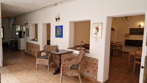 a living room with a table and chairs at Vila Studio Rasnov cu ciubar si sauna in Râşnov