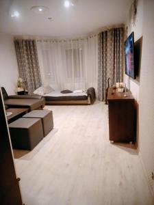 a large living room with a bed and a table at APaRTAMENT MOUTAIN SKY in Świeradów-Zdrój