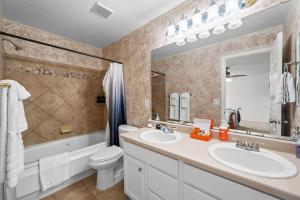 a bathroom with a sink and a toilet and a mirror at 1130 Mockingbird St in Brighton +36 photos
