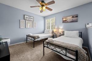 a bedroom with two beds and a ceiling fan at 1130 Mockingbird St in Brighton