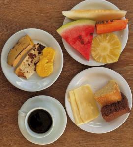 four plates of different types of food on a table at Pousada Estação Verde in Bonito