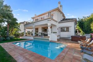 a home with a swimming pool and a house at Villa Picasso Marbella in Marbella