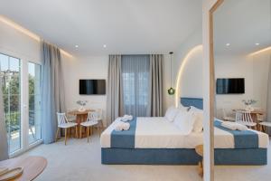 a hotel room with two beds and a balcony at Secret Garden Studios in Mytilene