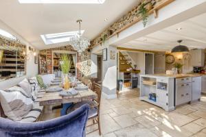 a kitchen and living room with a table and chairs at 5 Bed in Blofield oc-s33037 in Blofield