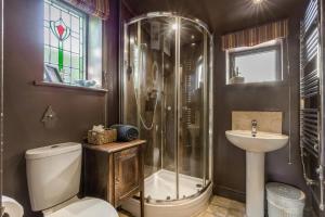 a bathroom with a shower and a toilet and a sink at 5 Bed in Blofield oc-s33037 in Blofield +33 photos