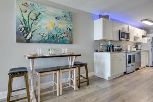 a kitchen with a table and stools in a room at Beach, Pool & Ocean View! North Myrtle Beach Condo in Myrtle Beach