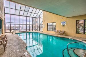 a large swimming pool with chairs and a large window at Beach, Pool & Ocean View! North Myrtle Beach Condo in Myrtle Beach