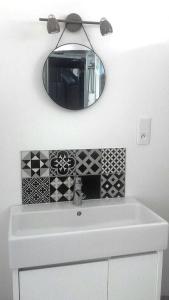 a bathroom with a white sink and a mirror at Studio confortable au calme - Terrasse privative in Labergement-Foigney