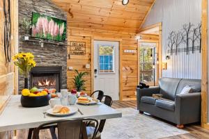 a living room with a table and a fireplace at Afterglow by Ghosal Luxury Lodging in Sevierville