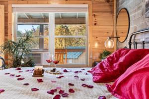 a room with a table with roses and wine glasses at Afterglow by Ghosal Luxury Lodging in Sevierville +34 photos
