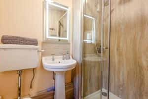 a bathroom with a sink and a shower at 2 Bed in Caldbeck oc-a32049 in Caldbeck +18 photos