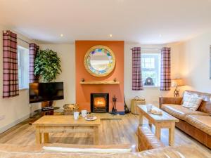 a living room with a couch and a fireplace at 3 Bed in Chathill oc-79566 in Beadnell