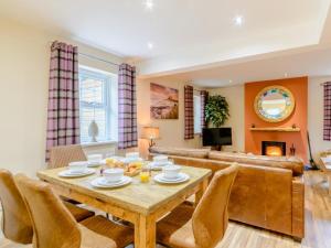 a living room with a table and chairs and a couch at 3 Bed in Chathill oc-79566 in Beadnell