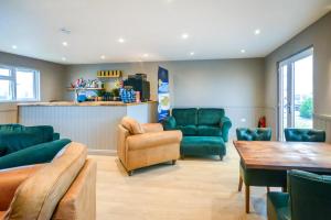a living room with green furniture and a table at 2 Bed in St. Merryn oc-p00883 in Saint Merryn