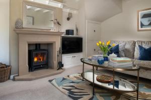 a living room with a couch and a fireplace at 2 Bed in Baslow oc-h32721 in Baslow