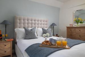 a bed with a tray of bread and orange juice at 2 Bed in Baslow oc-h32721 in Baslow