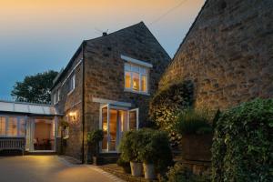 a brick house with windows and plants in front of it at 2 Bed in Baslow oc-h32721 in Baslow