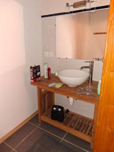 a bathroom with a sink and a mirror at La maison du meunier in Olette