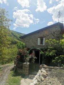 a stone house with a fence in front of it at La maison du meunier in Olette